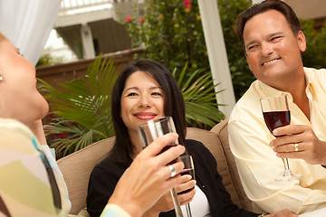 Image showing Three Friends Enjoying Wine on the Patio