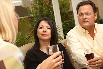 Image showing Three Friends Enjoying Wine on the Patio