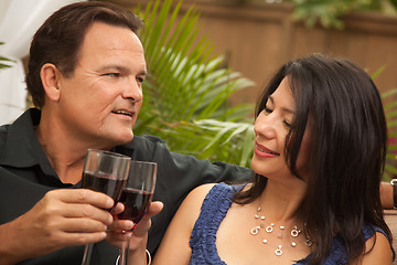 Image showing Attractive Hispanic and Caucasian Couple Drinking Wine