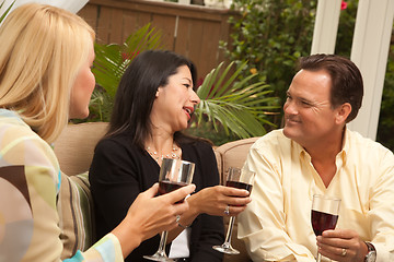 Image showing Three Friends Enjoying Wine on the Patio