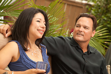 Image showing Attractive Hispanic and Caucasian Couple Drinking Wine