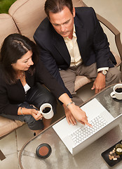 Image showing Man and Woman Using Laptop with Coffee