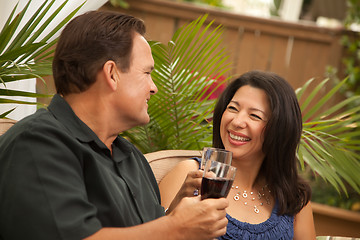 Image showing Attractive Hispanic and Caucasian Couple Drinking Wine