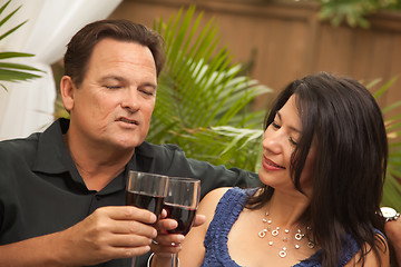 Image showing Attractive Hispanic and Caucasian Couple Drinking Wine