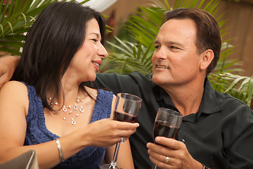 Image showing Attractive Hispanic and Caucasian Couple Drinking Wine