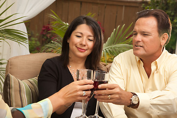 Image showing Three Friends Enjoying Wine on the Patio