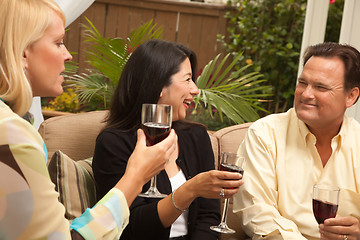 Image showing Three Friends Enjoying Wine on the Patio
