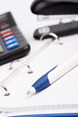 Image showing  business organizer, pen, calculator and stapler