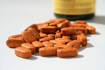 Image showing Pills next to a Container