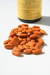 Image showing Pills next to a Container