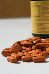 Image showing Pills next to a Container