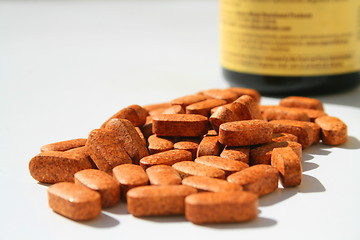 Image showing Pills next to a Container