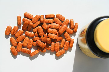 Image showing Pills next to a Container