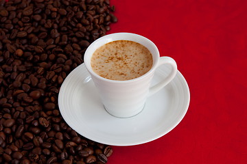 Image showing cup with coffee and grain expressed on red background