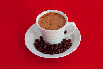 Image showing cup with coffee and grain expressed on red background