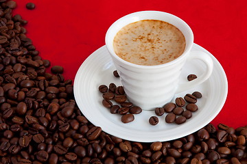 Image showing cup with coffee and grain expressed on red background