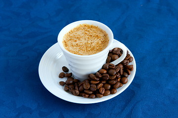 Image showing cup with coffee and grain expressed on blue background