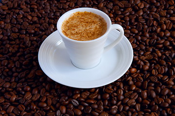 Image showing Cup with coffee, costing on coffee grain
