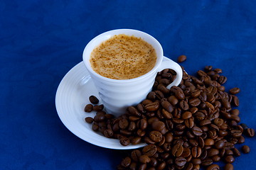 Image showing cup with coffee and grain expressed on blue background