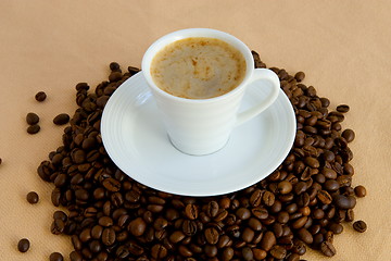 Image showing Cup with coffee, costing on coffee grain