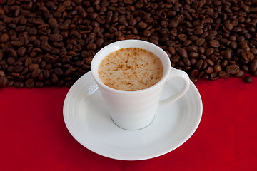 Image showing cup with coffee and grain expressed on red background