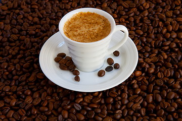 Image showing Cup with coffee, costing on coffee grain