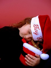 Image showing Sleeping little girl wearing santa hat