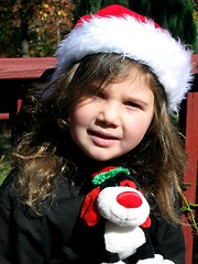 Image showing Pretty little girl outside wearing santa hat