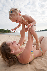 Image showing Mum with daughter play on beach