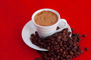 Image showing cup with coffee and grain expressed on red background