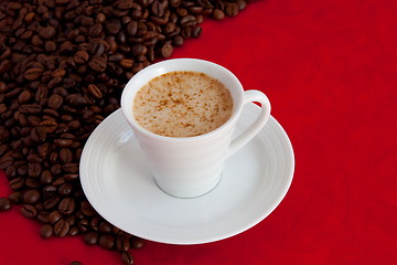 Image showing cup with coffee and grain expressed on red background