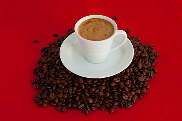 Image showing Cup with coffee, costing on coffee grain