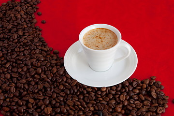 Image showing cup with coffee and grain expressed on red background