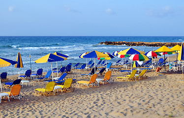 Image showing Sunbeds and beach umbrellas