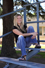 Image showing Woman Relaxing on Bleacher