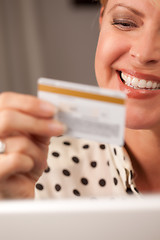 Image showing Beautiful Woman Using Laptop Holding Her Credit Card