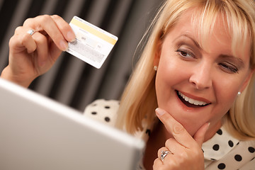 Image showing Beautiful Woman Using Laptop Holding Her Credit Card
