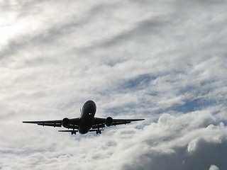 Image showing Landing plane silhouette on a cloudy day