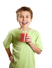 Image showing Smiling boy holding a fresh berry fruit juice