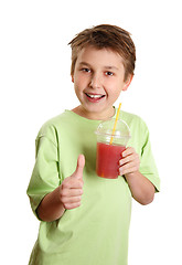 Image showing Healthy boy drinking juice thumbs up