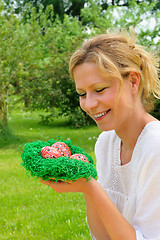 Image showing Young woman and easter eggs