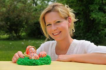 Image showing Young woman and easter eggs