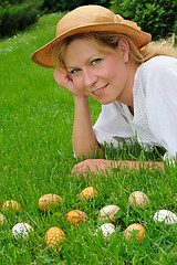 Image showing Young woman and easter eggs on the grass - Easter time