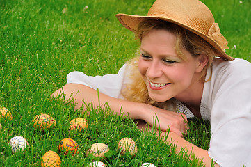 Image showing Young woman and easter eggs on the grass - Easter time