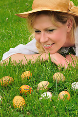 Image showing Young woman and easter eggs on the grass - Easter time