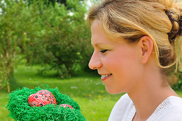 Image showing Young woman and easter eggs