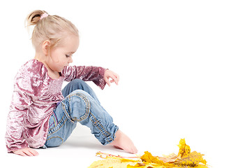 Image showing Toddler with maple leaves