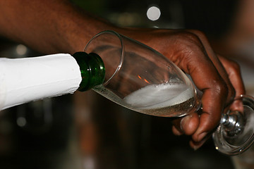 Image showing Waiter serving some Champaign