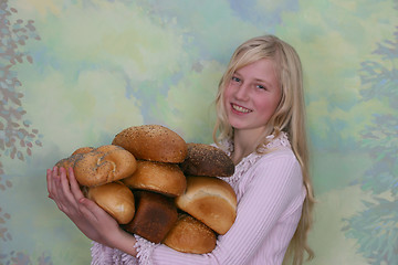 Image showing Girl with loafs of bread