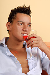 Image showing Smiling young man with cocktail